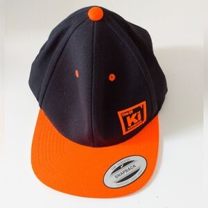 The DI Kindness Ki Wool Blend Snap Back Ball Cap O/S Orange and Black